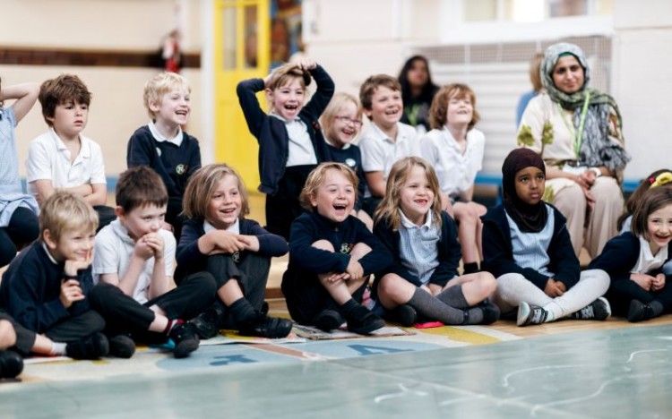 Children watching a children's theatre show in their school.